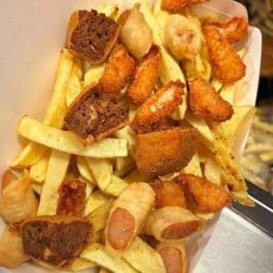 Chipper Trio Treat: Battered Sausage, Spice Burger, And Chicken Goujons, Tossed With Freshly Cut Chips And Dip Of Your Choice